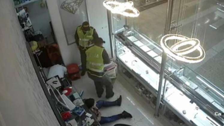Los dos falsos policías y un tercer individuo usaron un saco para empacar varias joyas y dinero en efectivo: / Foto: Captura de video